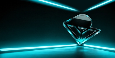 Turquoise-lit glass RHODESHIELD symbol in a dark room
