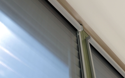 Lowered roller shade at the window, detail view from below