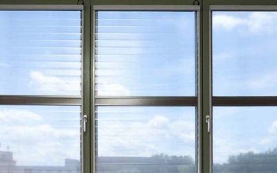 Window front with interior sun protection and a view of the sky